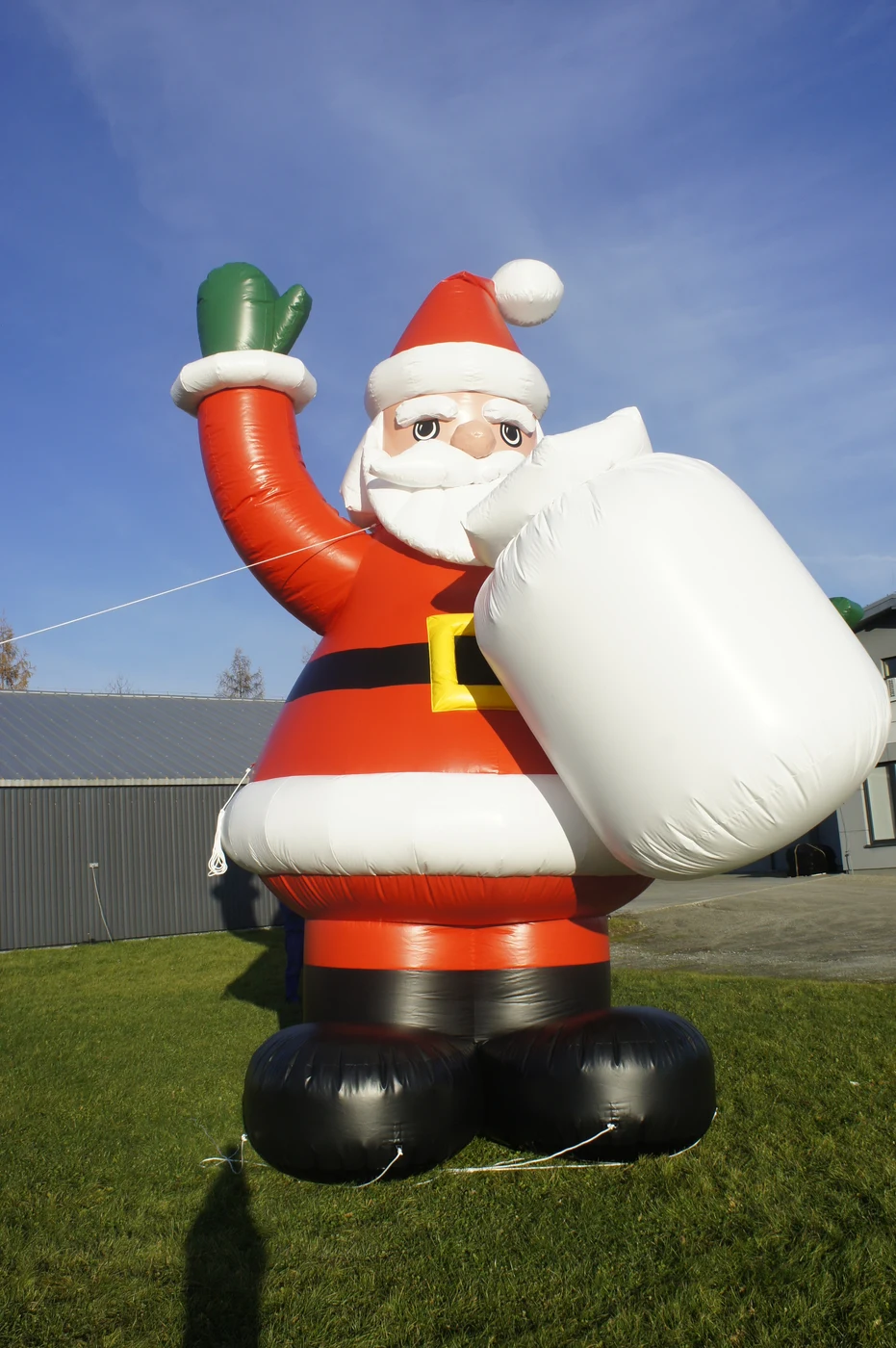 Inflatable Santa with a white sack and green mitten — reference photograph